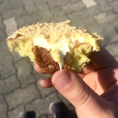 Lemon meringue donut, half-eaten