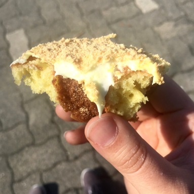 Lemon meringue donut, half-eaten